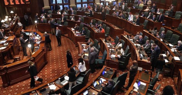 Lawmakers debate during a session at the Illinois State Capitol in Springfield, Ill. 