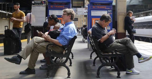 Passengers wait to board NJ Transit from Newark to New York City's Penn Station.